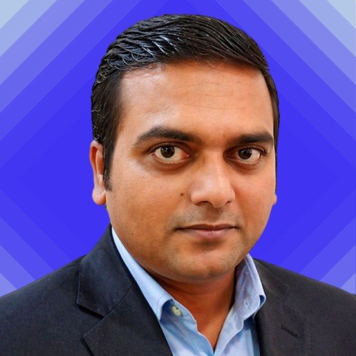 Atul smiling in front of camera